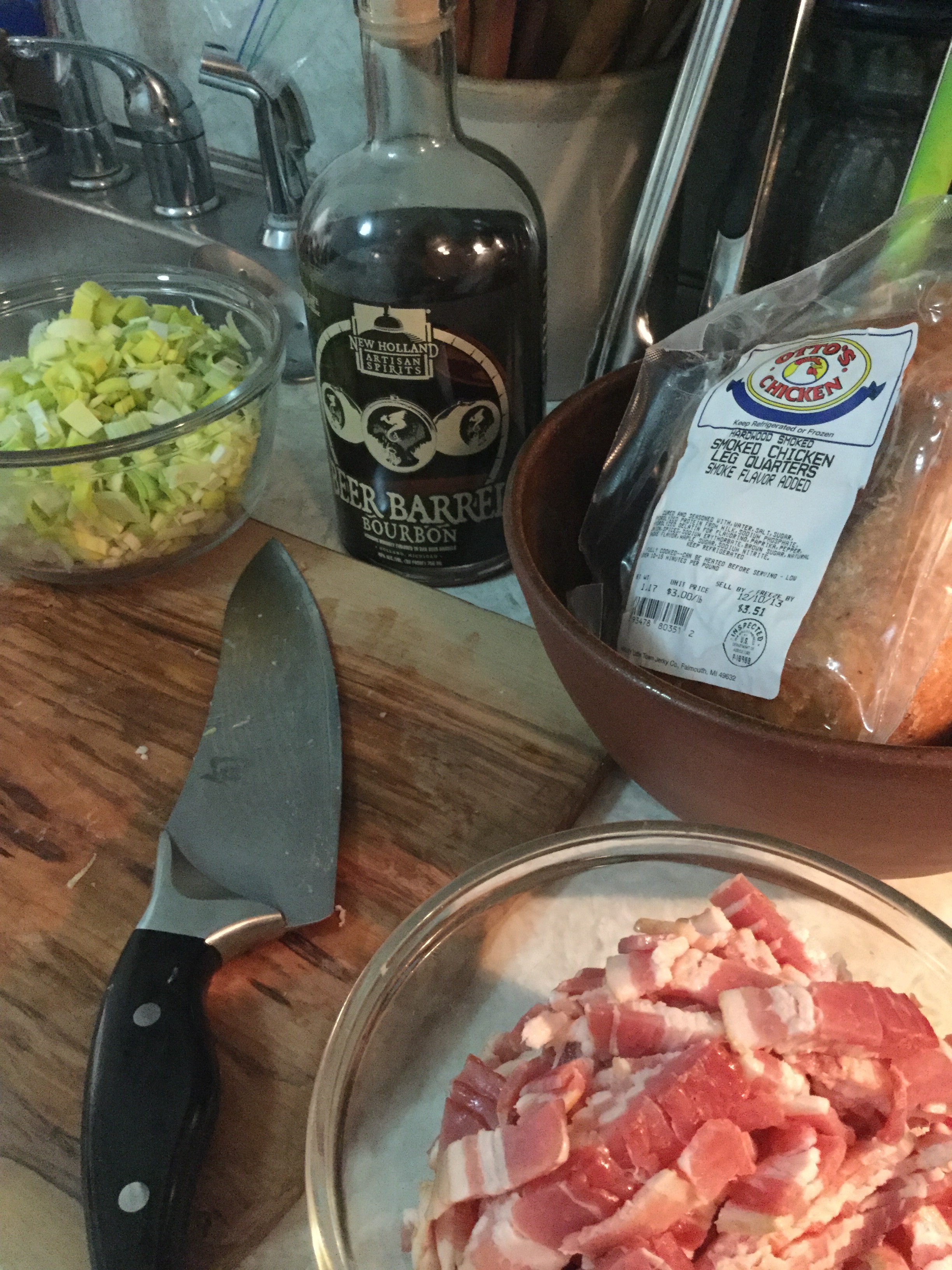 a mixture of cooked macaroni pasta tossed with cooked bacon, smoked chicken, and sautéed leeks